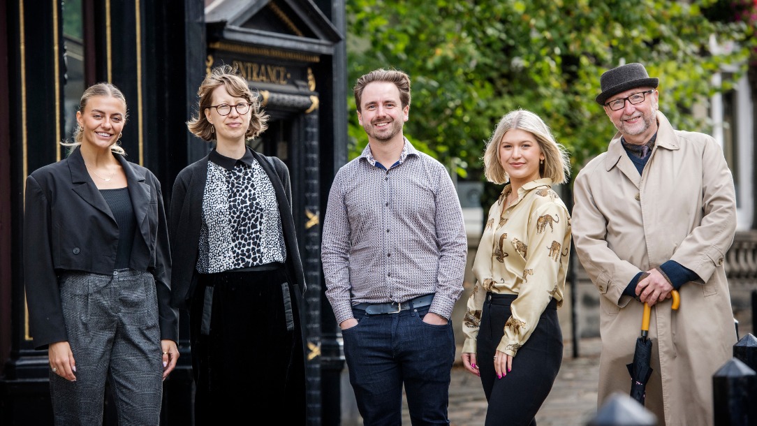 Three women and two men from Artus Digital Marketing standing in a street